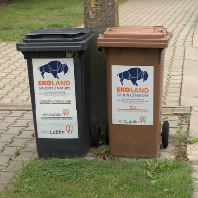 Origami-styled wisent logo of Ekoland company displayed on trash cans