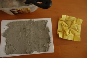 Plaster with a fresh impression, with original origami model (Tumbling Square Rosette)