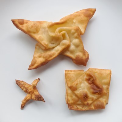 Several origami models folded from dough for angel wings, and fried
