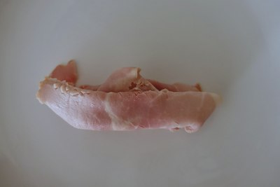 Traditional paper boat folded from a slice of ham